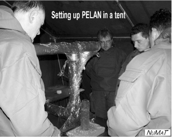 Jon Paschal (center with glasses), WKU alumnus and engineer at the Applied Physics Institute, sets up the PELAN in Belgium.  The clothing that he is wearing is chemical retardant.